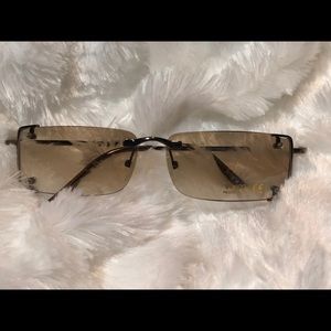 8 Tinted sunglasses with gold trim.